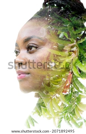 A portrait of an attractive woman combined with an image of fresh foliage. Dissolving into nature