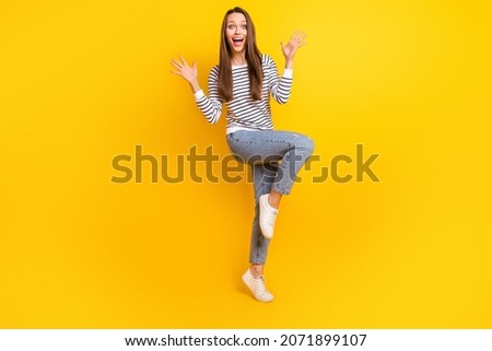 Full length photo of hooray brunette young lady dance wear jumper jeans footwear isolated on yellow color background