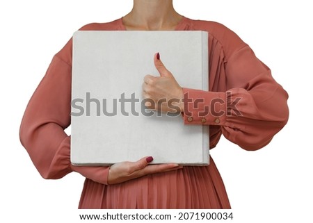 woman holds square wedding photo book with velor cover close up with copy space for text.
sample white family photo album in womans hands isolated on white background.  photoalbum with fabric cover. 