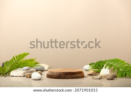 Wood podium with green leaves and natural stones. Abstract podium for organic cosmetic products. Natural stand for presentation and exhibitions. Front view Royalty-Free Stock Photo #2071901015
