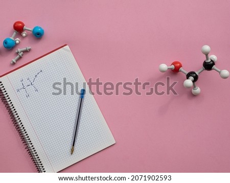 Chemical molecular models in representation of some organic molecules with lewis representation of ethanol on a notebook. Royalty-Free Stock Photo #2071902593