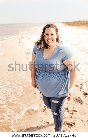 A young woman having fun during a photoshoot on the beach in Florida