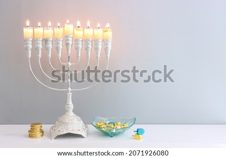 Religion image of jewish holiday Hanukkah background with menorah (traditional candelabra), spinning top and candles