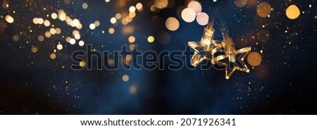 Christmas warm gold garland lights over dark background with glitter overlay Royalty-Free Stock Photo #2071926341