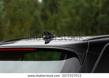 Modern car radio antenna. Shark fin antenna. Modern car roof. Royalty-Free Stock Photo #2071927013