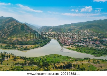 The top view of Mtskheta, Georgia. The historical town lies at the confluence of the rivers Mtkvari and Aragvi. Georgian landscape with blue sky above. Royalty-Free Stock Photo #2071936811