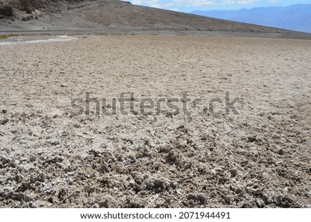 A photo of the dry surface floor  in Badwater Basin, Death Valley National Park, California, USA. Space for text. 