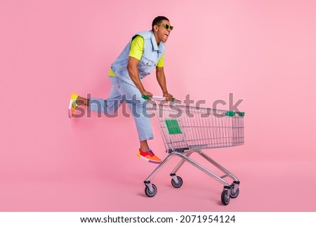 Full body profile photo of cool young brunet guy run do shopping wear eyewear t-shirt vest jeans sneakers isolated pink background Royalty-Free Stock Photo #2071954124