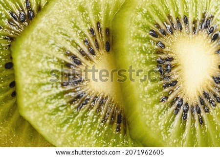 three slices of kiwi lie on top of each other
