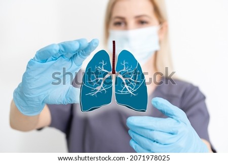 the doctor holds the lungs organ symbol. Awareness of lung cancer, pneumonia, asthma, COPD, pulmonary hypertension, world no tobacco day and eco air pollution. Respiratory and chest concept. Royalty-Free Stock Photo #2071978025