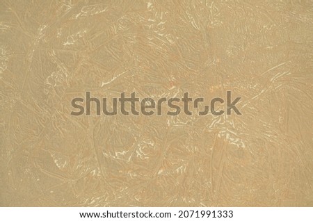 Embossed pattern made of decorative putty, beige, in places wiped out.
 background for text and interior design
