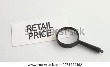 retail price word on paper and magnifying lens
