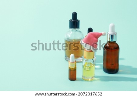Cosmetic oil and serum dropper bottles with pipette and christmas decor copy space