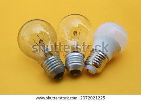 Three light bulbs isolated on yellow background