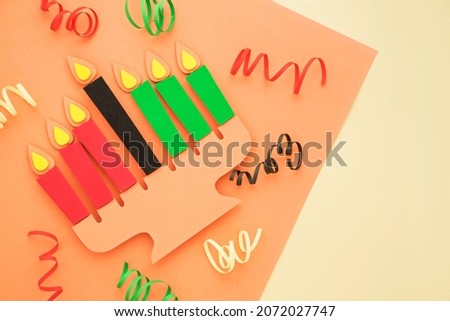 Happy Kwanzaa Greeting Card Background. Candleholder made from paper leaves. Paper art concept