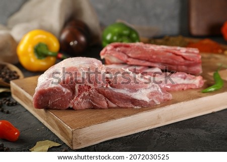 Beef navel, raw beef brisket on cutting bored and dark background
