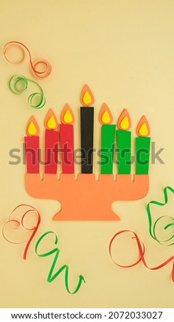 Happy Kwanzaa Greeting Card Background. Candleholder made from paper leaves. Paper art concept. Vertical banner mockup