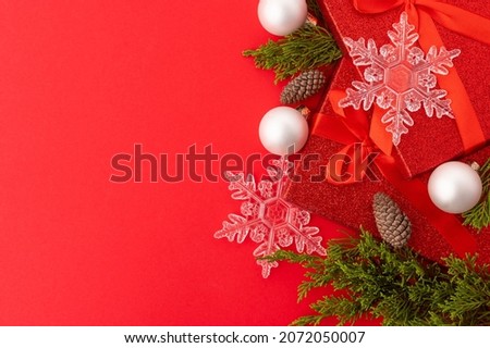 Beautiful Christmas and New Year composition on a red background. Symbols and attributes of winter holidays. Frame. postcard, congratulation, invitation. banner, poster.