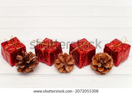 New Year's red gifts with cones. Christmas card. Picture. New Year.