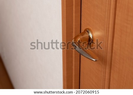 Doorknob in the house. Wooden door.