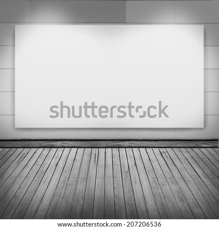 blank frame on white wall with spot light and wood floor in room for information message promotion at walkway.  