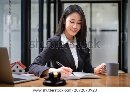 Business woman or lawyers working on wooden desk in office. Law, legal services, advice,Judge auction and real estate concept.