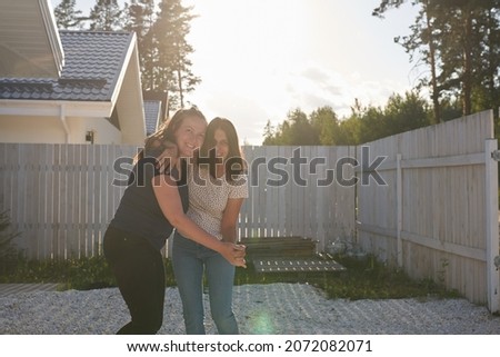 Friends have fun on a day off. Two friends hug and laugh together, positive emotions. High quality photo