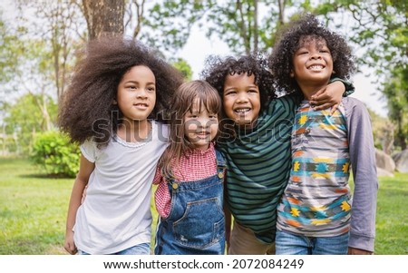 Portrait of four children having good time outdoor park, black caucasian children student together playground background. Home school education diversity multicultural community. Back to school.