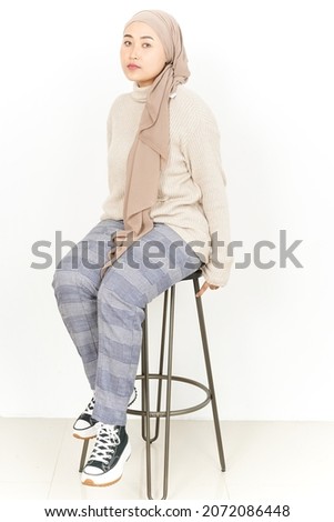 Young Asian woman wearing hijab doing some pose isolated on white background