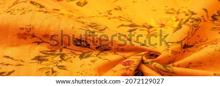 Yellow orange cotton fabric with floral print. Buy floral prints from independent artists and iconic brands. Texture, background,
