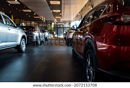 Rearview car parked in luxury showroom. Car dealership office. New car parked in modern showroom. Car for sale and rent business concept. Automobile leasing and insurance concept. Electric automobile. Royalty-Free Stock Photo #2072153708