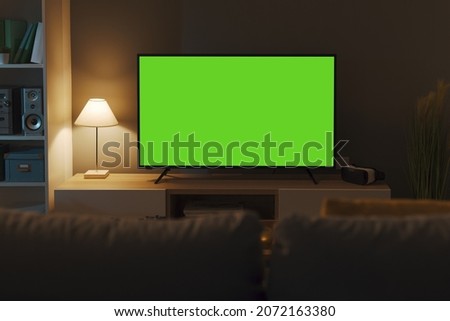 Television with horizontal green screen in the living room, entertainment and technology concept