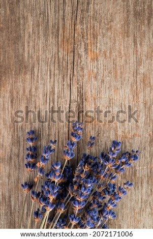 Bunch of dried lavender flowers on the rustic wooden background. Shot from above.