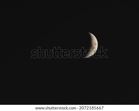 Telephoto of the waning moon in the early morning hours, space for text