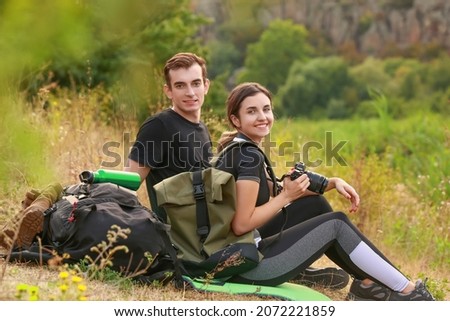 Couple of young tourists in countryside