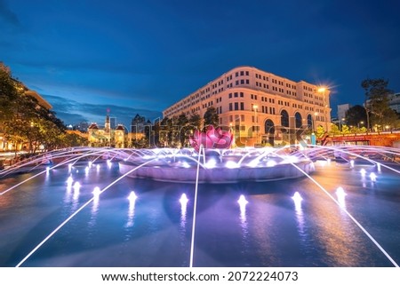 A lotus-shaped fountain with nice lights on Nguyen Hue street walking in front of Ho Chi Minh statue and Ho Chi Minh People's Committee, Saigon, Ho Chi Minh City, Vietnam.  Royalty-Free Stock Photo #2072224073
