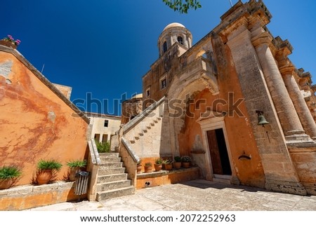 Beautiful picture of Governeto Christian orthodox monastery near Chania in Crete , Greece ,plants, palm trees , and old yellow stones