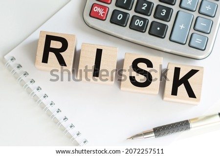RISK word written on wooden cubes. Financial risk assessment, risk reward and portfolio risk management concept.