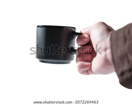Black mug in hand on isolated background