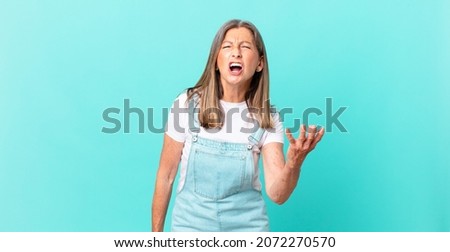 pretty middle age woman looking angry, annoyed and frustrated