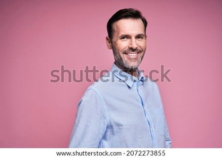 Portrait of handsome man in blue shirt                               