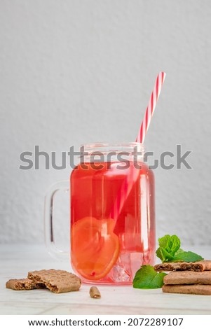 fruit lemon orange tea with cookies on wooden background, refreshing drink, summer mood. 
