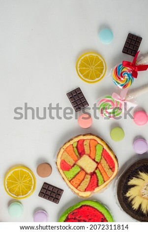 Colorful and various kind of sweets, candies and cake over white background