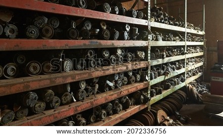 Salvage yard containing new, old, and rare cars, and trucks. Engine parts. Royalty-Free Stock Photo #2072336756