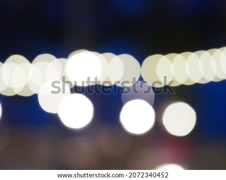 Blurred festive background with light bokeh in outdoor party