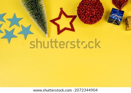Christmas elements with space for text with star, ball, gift box in a yellow background