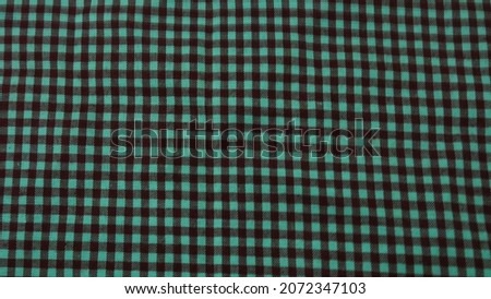 a photo of a cloth that has a small red and white checkered pattern defocused