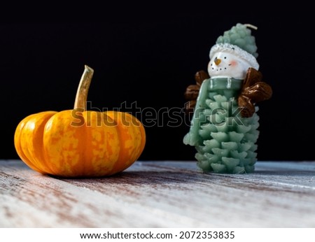 Pumpkin and a Christmas themed candle.