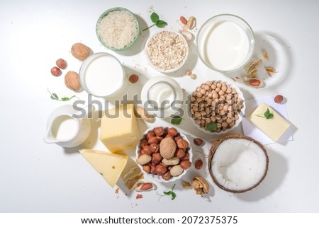 Vegan non-dairy products. Plant-based alternative dairy products – milk, cream, butter, yogurt, cheese, with ingredients - chickpeas, oatmeal, rice, coconut, nuts Royalty-Free Stock Photo #2072375375