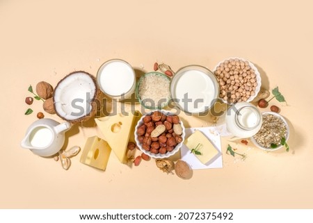 Vegan non-dairy products. Plant-based alternative dairy products – milk, cream, butter, yogurt, cheese, with ingredients - chickpeas, oatmeal, rice, coconut, nuts Royalty-Free Stock Photo #2072375492
